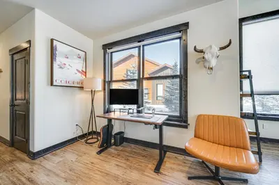 a room with a desk with a computer and a cow head on the wall at 8 Mi to Keystone Resort Mtn-View Townhome in Silverthorne