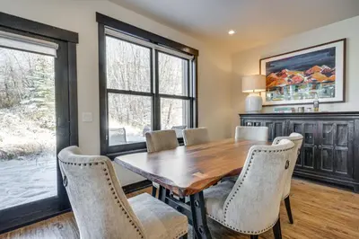 a dining room with a wooden table and chairs at 8 Mi to Keystone Resort Mtn-View Townhome in Silverthorne