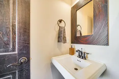 a bathroom with a sink and a mirror at 8 Mi to Keystone Resort Mtn-View Townhome in Silverthorne