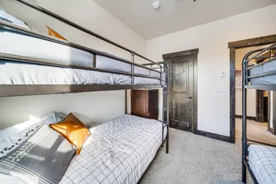 a bedroom with two bunk beds and a doorway at 8 Mi to Keystone Resort Mtn-View Townhome in Silverthorne