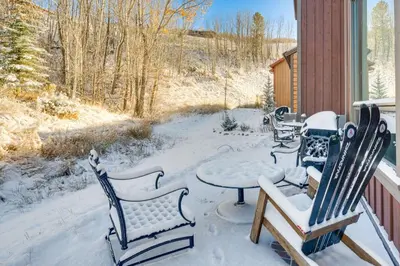 a patio with a table and chairs in the snow at 8 Mi to Keystone Resort Mtn-View Townhome in Silverthorne