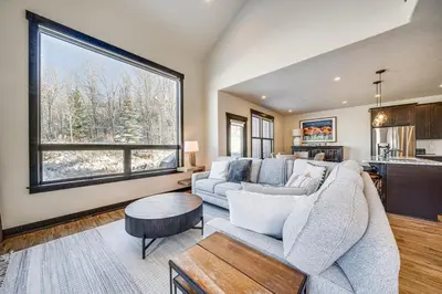 a living room with a couch and a large window at 8 Mi to Keystone Resort Mtn-View Townhome in Silverthorne