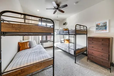 a bedroom with two bunk beds and a ceiling fan at 8 Mi to Keystone Resort Mtn-View Townhome in Silverthorne
