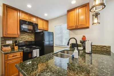 a kitchen with a sink and a counter top at Code & Comfort | Boston Commons in Englewood