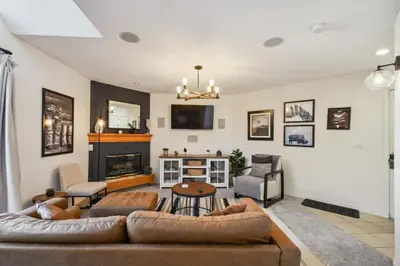 a living room with a couch and a fireplace at Code & Comfort | Boston Commons in Englewood