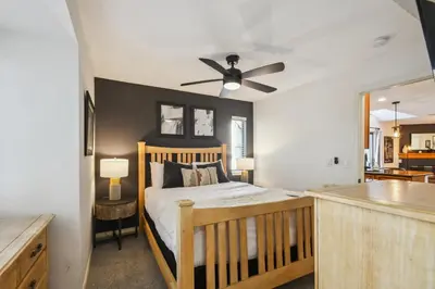 a bedroom with a bed and a ceiling fan at Code & Comfort | Boston Commons in Englewood