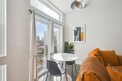 a living room with a couch and a table and a window at Urban Elegance | Espadin LoHi in Denver