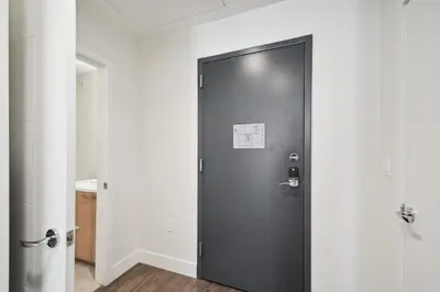 a black door in a room with white walls at Urban Elegance | Espadin LoHi in Denver