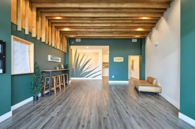 an empty lobby with a couch and a table at Urban Elegance | Espadin LoHi in Denver