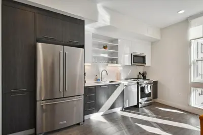 a kitchen with a stainless steel refrigerator at Urban Elegance | Espadin LoHi in Denver