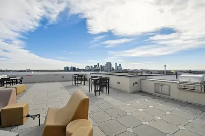 a patio with chairs and tables on a roof at Urban Elegance | Espadin LoHi in Denver
