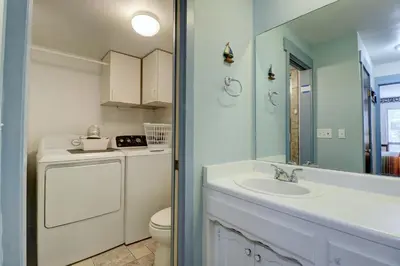a bathroom with a sink and a washer and dryer at A106 Lake Cliffe condo in Dillon