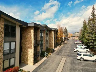 an apartment building with cars parked in a parking lot at A106 Lake Cliffe condo in Dillon
