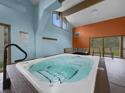 a jacuzzi tub in a room with a large window at A106 Lake Cliffe condo in Dillon