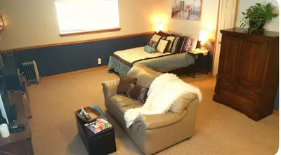 a living room with a couch and a bed at Cozy Garden Level Apartment Studio by Lake Loveland in Loveland