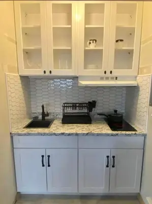 a kitchen counter with white cabinets and a sink at Cozy Garden Level Apartment Studio by Lake Loveland in Loveland