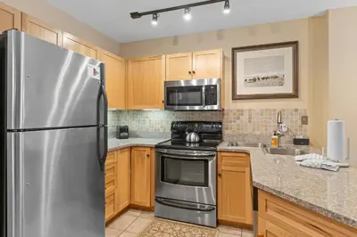 a kitchen with a stainless steel refrigerator and microwave at Buffalo Lodge 8386 in Keystone