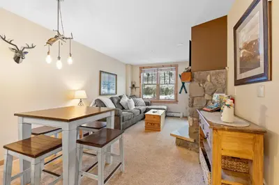 a living room with a table and a couch at Buffalo Lodge 8386 in Keystone