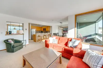 a living room with a red couch and a table at 2 Mi to Winter Park Resort Condo with Pool Access! in Winter Park