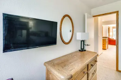 a living room with a flat screen tv on a wall at 2 Mi to Winter Park Resort Condo with Pool Access! in Winter Park
