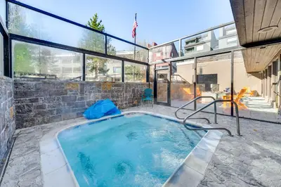 a large swimming pool in a house with glass windows at 2 Mi to Winter Park Resort Condo with Pool Access! in Winter Park