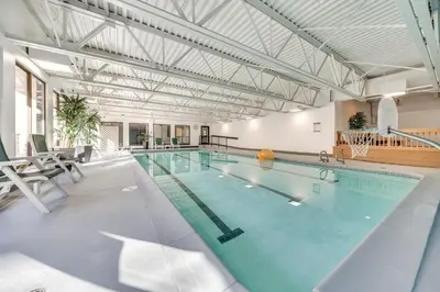 a large swimming pool in a building at 2 Mi to Winter Park Resort Condo with Pool Access! in Winter Park
