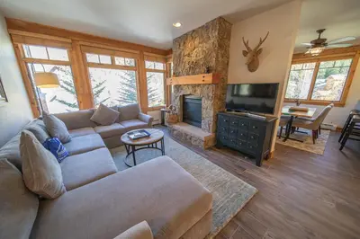 a living room with a couch and a fireplace at Settlers Creek 6536 by SummitCove Lodging in Keystone
