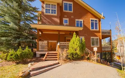 a house with a porch and a driveway at Settlers Creek 6536 by SummitCove Lodging in Keystone