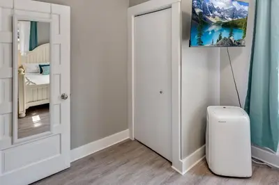 a room with a door leading to a bedroom at 94 WalkScore King Bed Capitol Hill Beachy Apt in Denver