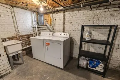 a laundry room with a stove and a shelf at 94 WalkScore King Bed Capitol Hill Beachy Apt in Denver