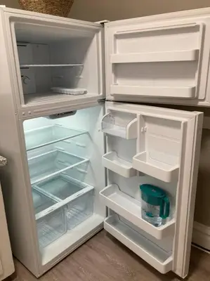 a white refrigerator with its door open with its door openktopktopktopktopktop at 94 WalkScore King Bed Capitol Hill Beachy Apt in Denver