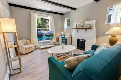 a living room with a blue couch and a fireplace at 94 WalkScore King Bed Capitol Hill Beachy Apt in Denver