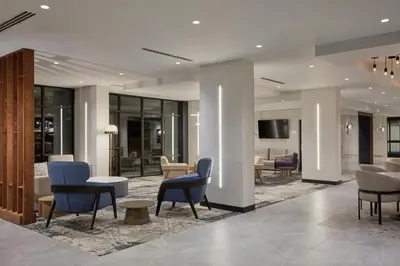 a lobby with chairs and tables in a building at Courtyard by Marriott Denver Downtown West in Denver