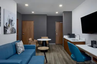 a living room with a couch and a table at Courtyard by Marriott Denver Downtown West in Denver