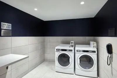 a laundry room with a washing machine and a phone at Courtyard by Marriott Denver Downtown West in Denver