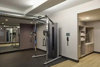 a gym room with a row of shower stalls at Courtyard by Marriott Denver Downtown West in Denver