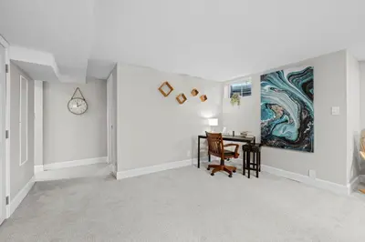 a dining room with a table and a painting on the wall at Iola in Aurora