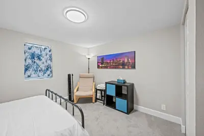 a bedroom with a bed and a desk and a chair at Iola in Aurora