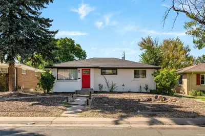 a house with a red door on a street at Iola in Aurora