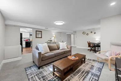 a living room with a couch and a table at Iola in Aurora