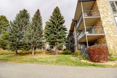 an apartment building with trees in front of it at A105 Lake Cliffe condo in Dillon