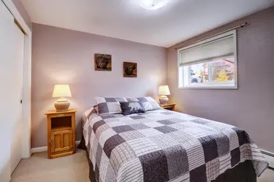 a bedroom with a bed and two lamps on tables at Yacht Club 27 condo in Dillon