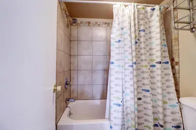 a bathroom with a tub and a shower curtain at Yacht Club 27 condo in Dillon