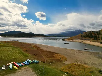 a group of boats parked on the shore of a river at Yacht Club 27 condo in Dillon