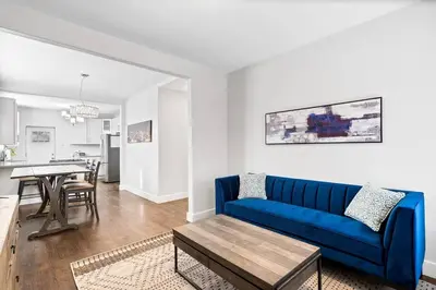 a living room with a blue couch and a table at Updated 2 Bedroom home near Downtown! in Denver