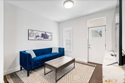 a living room with a blue couch and a table at Updated 2 Bedroom home near Downtown! in Denver