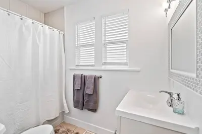a white bathroom with a sink and a toilet at Updated 2 Bedroom home near Downtown! in Denver
