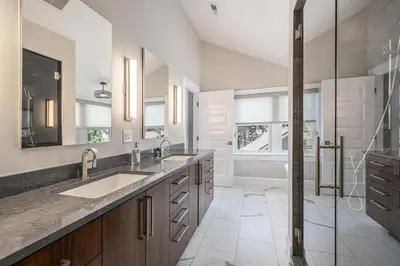 a bathroom with two sinks and a shower at Secret Garden Retreat in Park Hill in Denver