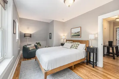 a bedroom with a bed and a chair at Secret Garden Retreat in Park Hill in Denver