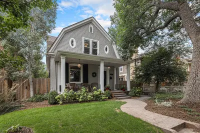 a gray house with a porch and a yard at Secret Garden Retreat in Park Hill in Denver